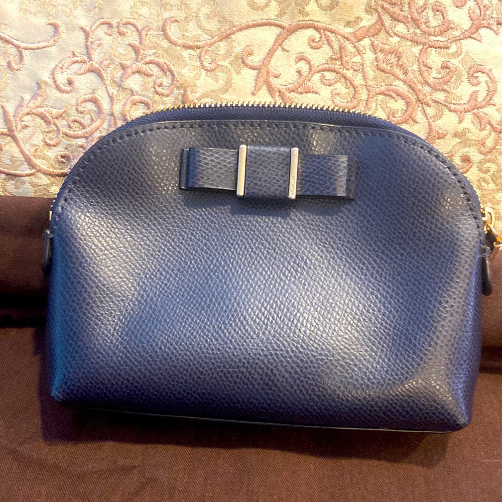 Navy blue Coach Bow tie cosmetics bag.